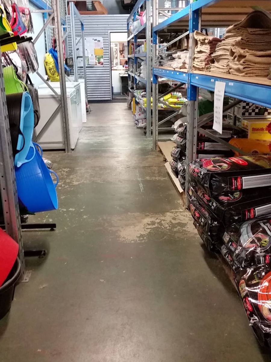 Feed bags stacked high inside Mandurah Stock Feeds